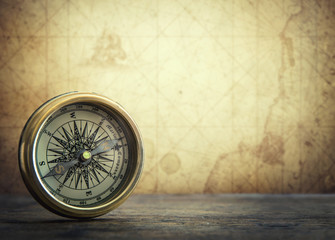 Fototapete - Old vintage retro compass on ancient map background. Travel geography navigation concept background.