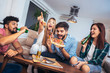 © Mediteraneo - Group of young friends eating pizza.Home party.Fast food concept.