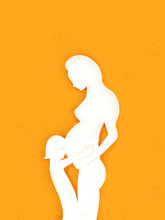 Silhouette Of A Pregnant Mother With A Toddler Hugging Her Bump 