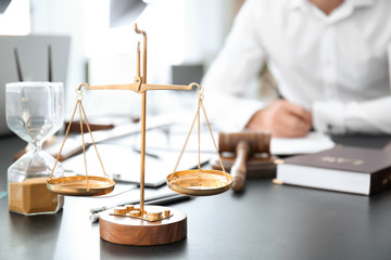 Wall Mural - Scales of justice on table in lawyer's office