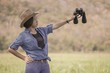 © Singha songsak - Woman wear hat and hold binocular in grass field