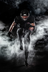 American football sportsman player isolated on black background