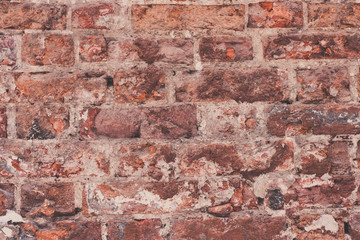 Wall Mural - Ancient masonry of weathered bricks close-up - a vintage rough background