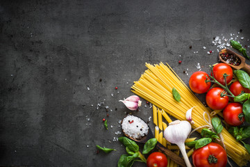 Wall Mural - Italian Food background on black stone table. Top view.