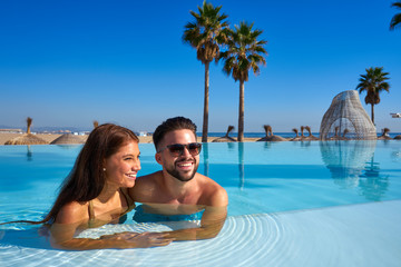 Wall Mural - Tourist couple having bath in infinity pool