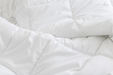 White bedding sheets background. Messy bed concept.