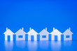 a paper cutout row of houses blue background