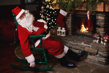 Santa Claus, Sleeping In Chair Beside Fireplace