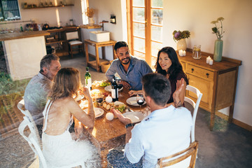 Wall Mural - Friends gathering for a dinner party