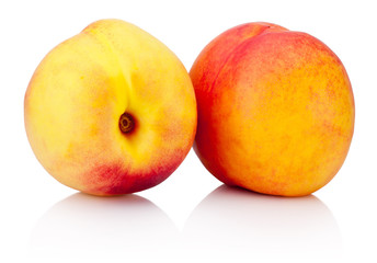 Wall Mural - Two nectarine fruit with green leaf isolated on a white background