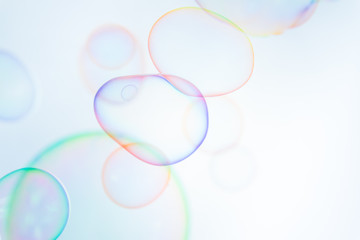 Abstract bright colorful of soap bubbles float on white background