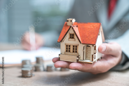 Cuadros en Lienzo Businessman as a property agent or investor calculating growth of return on inve