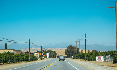 Poster - Agricultural fields in Sierra Nevada. Highway in rural California