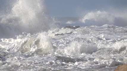 Wall Mural - Splashes from atlantic ocean big waves over cliffs, slow motion
