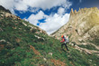 © lzf - young woman with backpack hiking in mountains