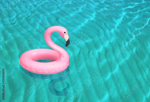 Fotografía Inflatable pink flamingo floating on the sea surface