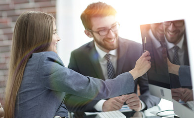 Wall Mural - colleagues discussing information on a computer