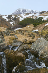 Wall Mural - Winter valley with the rocks and orange dry grass with the big mountain with snow in the Island