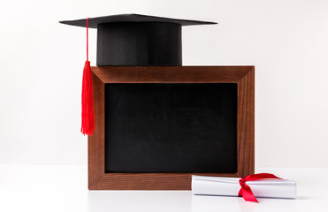 Sticker - Square academic cup on empty blackboard and diploma isolated on white