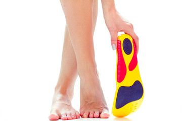 Wall Mural - orthopedic insoles and female feet