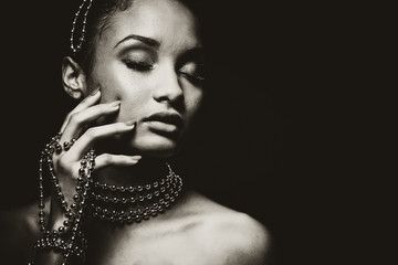 beautiful woman wearing chain jewellery in black and white photo