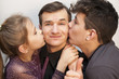 © Мар'ян Філь - Kids hug and kiss their happy father's cheeks and everyone smiles. Focus on father. They together celebrate the Father's Day