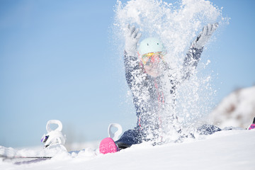  Image of sports woman sitting in snowdrift, snow-throwing