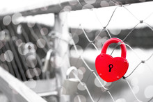 A Red Love Padlock Fastened To A Bridge Railing