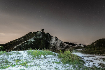 Dark night sky over the high chalk hill. Night natural landscape. Belgorod region, Russia.