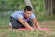 © auremar - man stretching out muscles in park