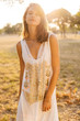 © FrameWorks/Stocksy - Portrait of beautiful young woman standing outdoors during summer