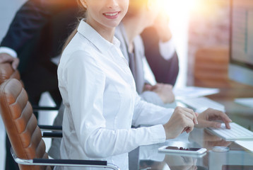 Poster - young employee sitting at a Desk