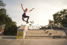 Male Teenager Performing Midair Tricks With Skateboard
