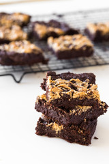 Chocolate Tahini Brownies Stacked in a White Table