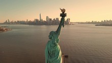 Statue Of Liberty At Beautiful Sunset - Aerial Circling Toward Manhattan Skyline In New York City NYC In 4K And 1080 HD