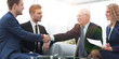 © ASDF - Partners concluding deal and shaking hands in the presence of te