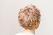 © EdNurg - rear view of a young woman with short colored haircut on studio background with copy space