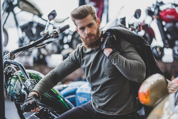 Wall Mural - Man in motorcycle shop