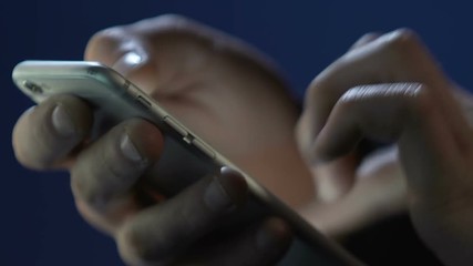 Male hands using smartphone application, surfing internet, texting message