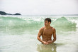 © theartofphoto - Handsome young man standing on a beach in Phuket Island, Thailand, shirtless wearing boxer shorts, showing muscular fit body