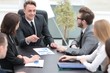 © ASDF - businessman at a meeting with employees