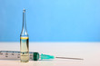 Set Ampule medical glass on white table with blue background. Syringe, needle.