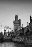 Fototapeta Miasto - Black-and-white photograph of the Charles bridge. Prague's historical center, photo from the river.