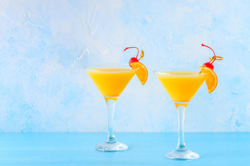 Wall Mural - Yellow cocktail on a bright background.