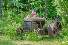 Deserted Old Tractor With American Flag