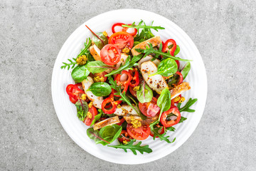 Wall Mural - Fresh vegetable salad plate of tomatoes, spinach, pepper, arugula, chard leaves and grilled chicken breast. Fried chicken meat, fillet with salad. Healthy food. Diet dinner or lunch. Salad plate 