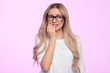 © DimaBerlin - Worried young woman looks nervous, bites finger, isolated. Female in eyeglasses feels frustrated due to an awkward situation, has a problem, has no idea what to do. Worrying talk concept