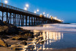 The Oceanside, California fishing pier with lights at dawn.  