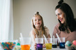 © MeganBetteridge - Mother and Daughter Painting Easter Eggs together