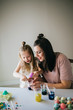 © MeganBetteridge - Mother and Daughter Painting Easter Eggs together
